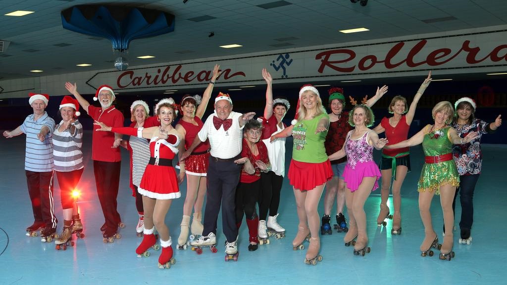 Aubrey Gamble wears a big bowtie, and is surrounded by other skaters at the Rollerama rink.