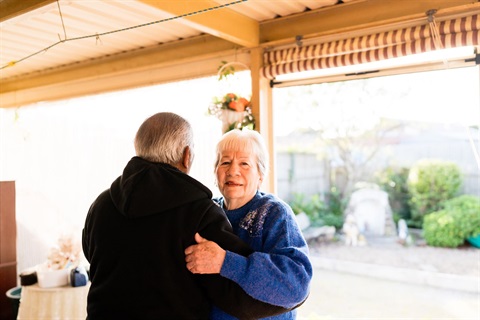 Husband and wife dance together in thier backyard