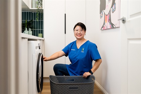 AccessCare support worker does a client's laundry.