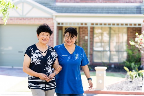 An AccessCare support worker goes for a walk with a client.