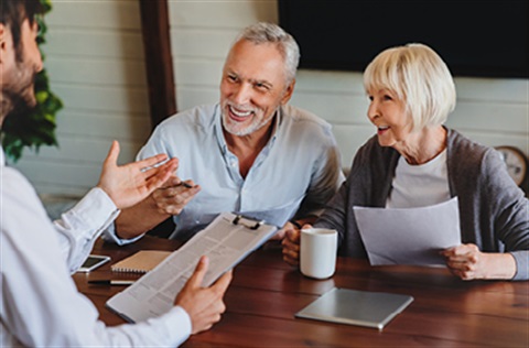 man talking with older couple