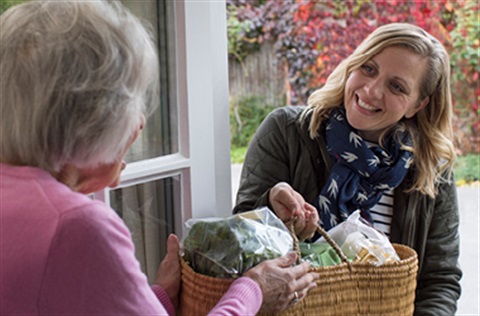 lady brings shopping to elderly lady