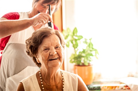 Older woman receives hair care