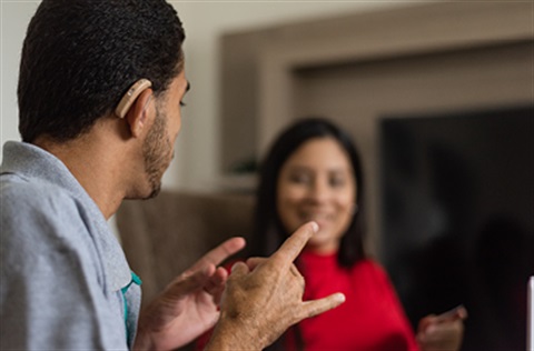 Man and woman talking in sign language
